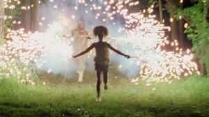 Quvenzhane Wallis as "Hushpuppy" enjoys the lights of sparklers in "BEASTS OF THE SOUTHERN WILD." ©20th Century Fox. CR: Ben Richardson.