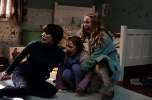 Surrogate mom Annabel (Jessica Chastain) encounters an undead rival for the affections of Lilly (Isabelle Nélisse) and Victoria (Megan Charpentier) in "Mama." ©Universal Studios CR: George Kraychyk.