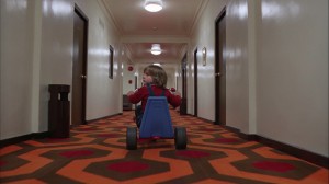 Danny Lloyd rides his tricylce past Room 237 in "The Shining." ©Warner Bros. Pictures.