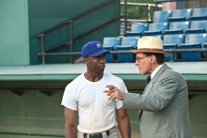 (L-r) CHADWICK BOSEMAN as Jackie Robinson and HARRISON FORD as Branch Rickey in "42." ©Warner Bros. Entertainment/Legendary Pictures Productions. CR: D Steven