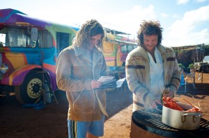 JB (Sam Worthington, right) prepares a meal on the beach as Jimmy (Xavier Samuel) looks on in "Drift." ©Lionsgate Entertainment.