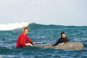 (l-r) Andy (Myles Pollard) and JB (Sam Worthington) keep on the lookout for JImmy (Xavier Samuel) as he tries to catch a wave in "Drift." ©Lionsgate Entertainment.