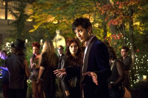 (l-r) Clary (Lily Collins) watches as Magnus Bane (Godfrey Gao) greets his guests in Screen Gems fantasy-action "THE MORTAL INSTRUMENTS: CITY OF BONES." ©Constantin Film International GmbH and Unique Features (TMI) Inc. CR: Rafy.