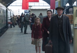 Liesel (Sophie Nélisse) meets her new foster parents, Hans (Geoffrey Rush) and Rosa (Emily Watson) in "The Book Thief." ©20th Century Fox. CR: Jules Heath.