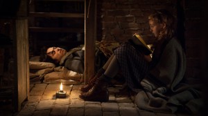 Liesel (Sophie Nélisse) reads to Max (Ben Schnetzer), who’s hiding in her home in "The Book Thief." ©20th Century Fox. CR: Jules Heath.