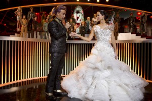 Caesar Flickerman (Stanley Tucci) and Katniss Everdeen (Jennifer Lawrence) in "THE HUNGER GAMES: CATCHING FIRE." ©Lionsgate Entertainment. CR: Murray Close.