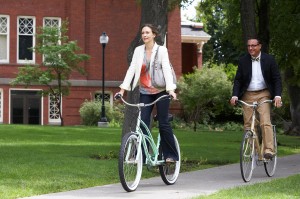 Edith (Vera Farmiga) and George (Andy Garcia) peddle their way through campus in AT MIDDLETON. ©Anchor Bay.