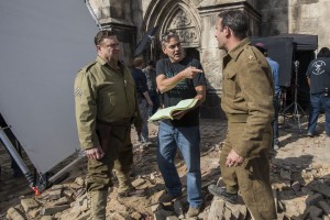 (l to r) John Goodman, director George Clooney and Jean Dujardin on the set of Columbia Pictures' THE MONUMENTS MEN. ©Columbia Pictures. CR: Claudette Barius.