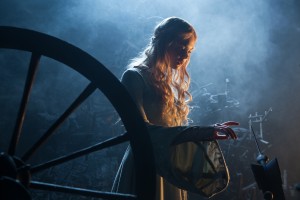 Princess Aurora (Elle Fanning) about to touch the needle in Disney's "MALEFICENT."  ©Disney Enterprises. CR: Frank Connor.