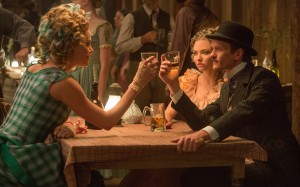 (L to R) Anna (CHARLIZE THERON) has a few drinks with Louise (AMANDA SEYFRIED) and Foy (NEIL PATRICK HARRIS) in "A Million Ways to Die in the West." ©Universal Studios. CR: Lorey Sebastian.