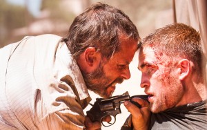 (l-r) Guy Pearce and Robert Pattinson in THE ROVER. ©A24Films.