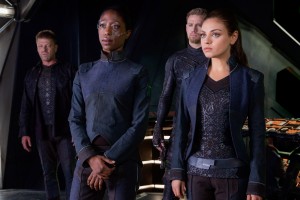 SEAN BEAN as Stinger Apini (far left), (middle background to right) CHANNING TATUM as Caine Wise and MILA KUNIS as Jupiter Jones in JUPITER ASCENDING. ©Warner Bros. Entertainment.