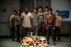 The surviving Gladers react to something they hadn’t seen a long time: a feast…courtesy of WCKD.  (left to right) Glader (Gary Hood), Teresa (Kaya Scodelario), Frypan (Dexter Darden), Thomas (Dylan O’Brien), Minho (Ki Hong Lee), Newt (Thomas Brodie-Sangster), Winston (Alexander Flores) and Jack (Bryce Romero) in MAZE RUNNER: THE SCORCH TRIALS. ©20th Century Fox. CR: Richard Foreman, Jr. SMPSP.