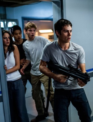 Thomas (Dylan O’Brien, right) leads Teresa (Kaya Scodelario), Minho (Ki Hong Lee), and Newt (Thomas Brodie-Sangster) in a daring escape from WCKD in MAZE RUNNER: THE SCORCH TRIALS. ©20th Century Fox. CR: Richard Foreman, Jr. SMPSP.