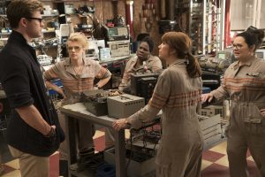 The Ghostbusters Holtzmann (Kate McKinnon), Patty (Leslie Jones), Erin (Kristen Wiig), Abby (Melissa McCarthy) with their receptionist Kevin (Chris Hemsworth) in Columbia Pictures' GHOSTBUSTERS. ©CTMG. CR: Hopper Stone.
